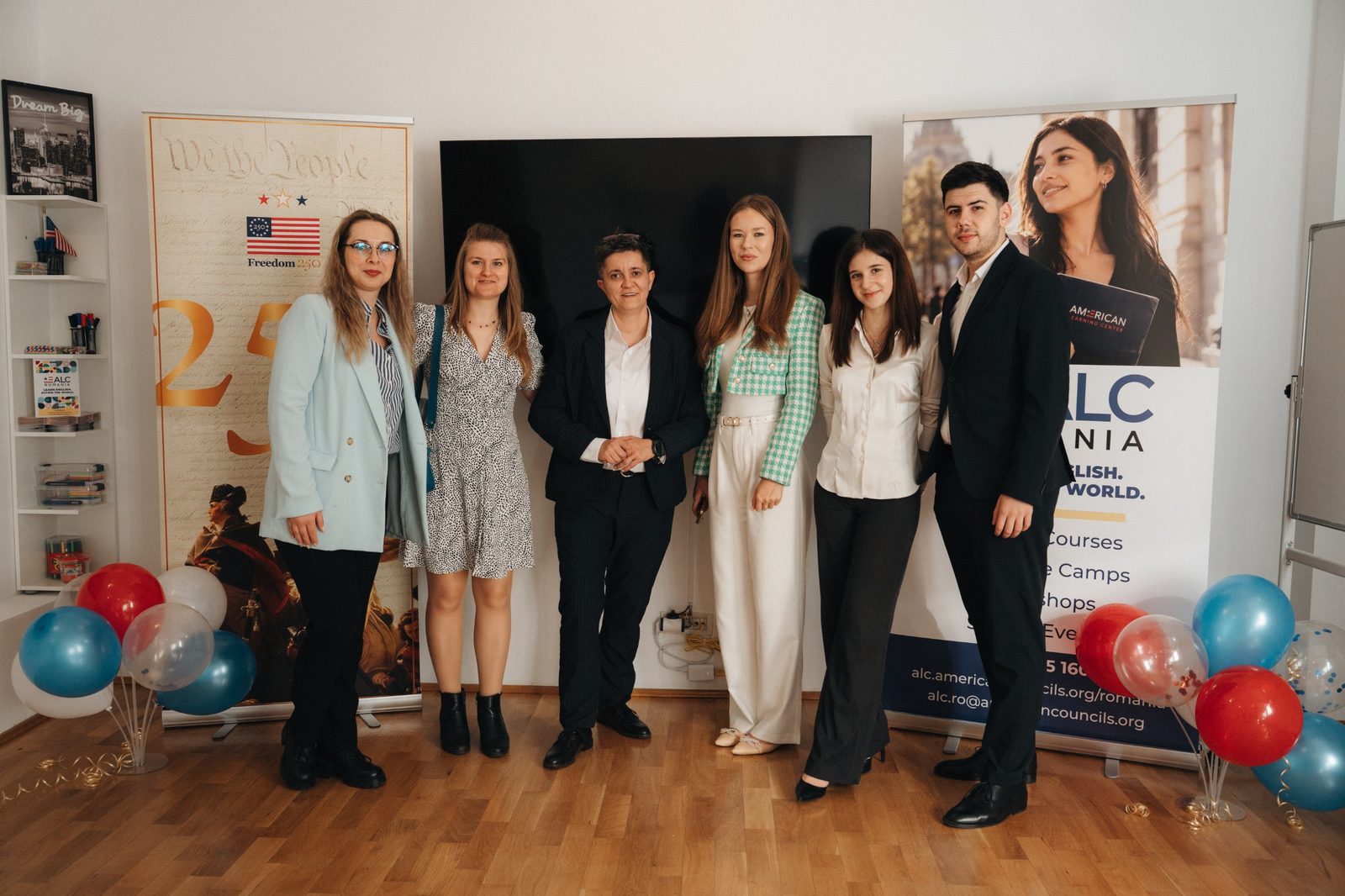 Group photo in front of the ALC Romania banners